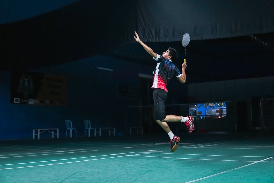 Badminton athlete rising for an overhead smash